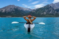 Paddling canoeist enjoy the mountain scenery